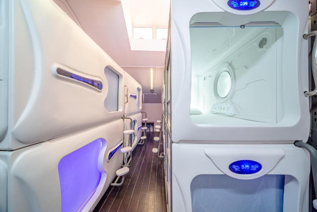 an aisle of an airplane with blue lights at K Space Inn 569 in Singapore