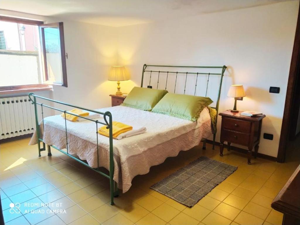 a bedroom with a bed with a metal frame at La Chicca 5 posti letto in Capannori