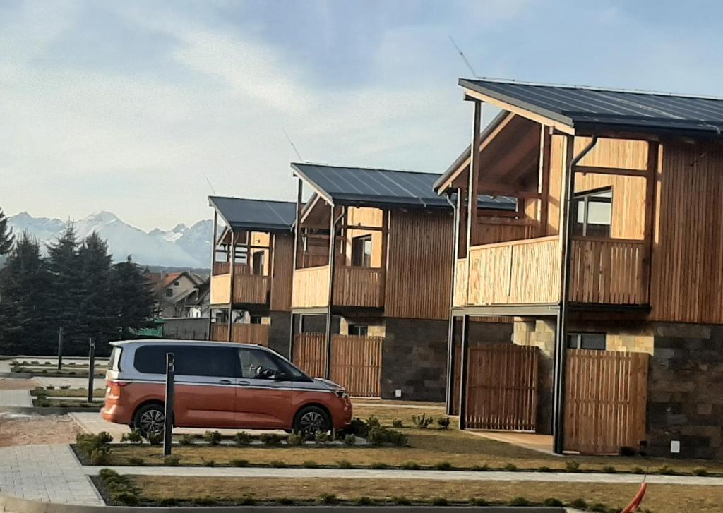 a van parked in front of a row of houses at Apartmán B4 Hrabušice in Hrabušice