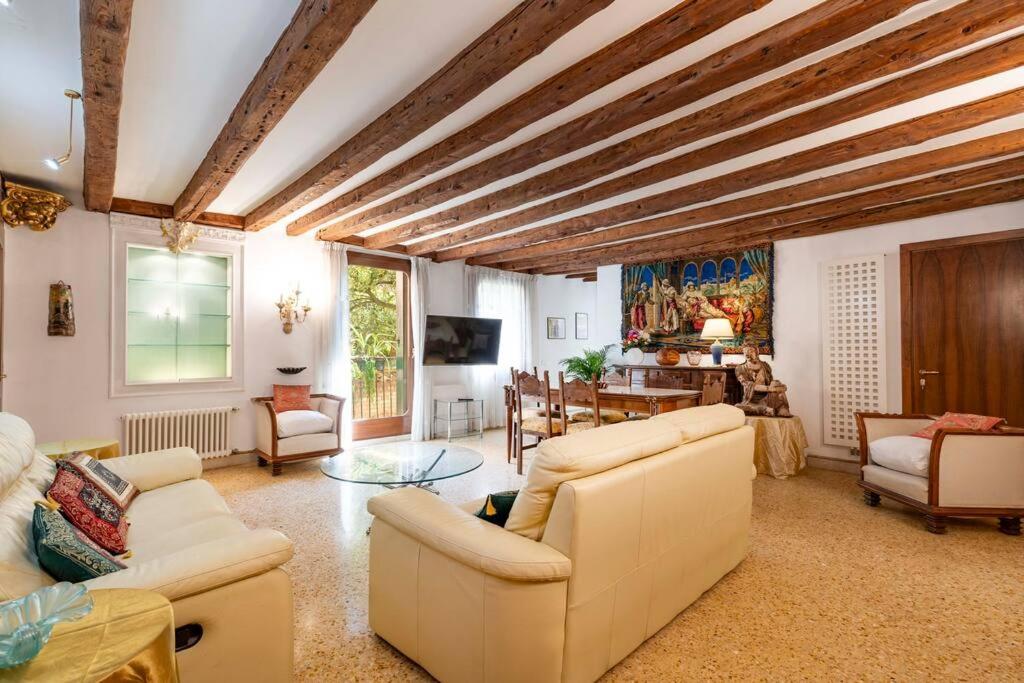a living room with white furniture and a wooden ceiling at Ca' Mandorla 027042loc09523 in Venice