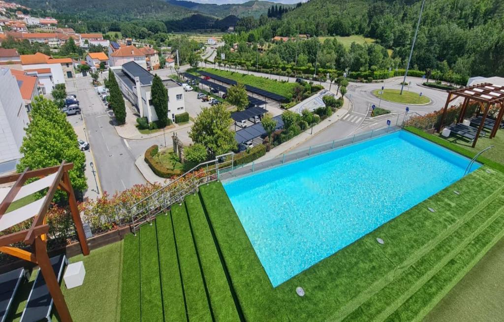 an overhead view of a large swimming pool in a park at Boticas Hotel Art & SPA in Boticas