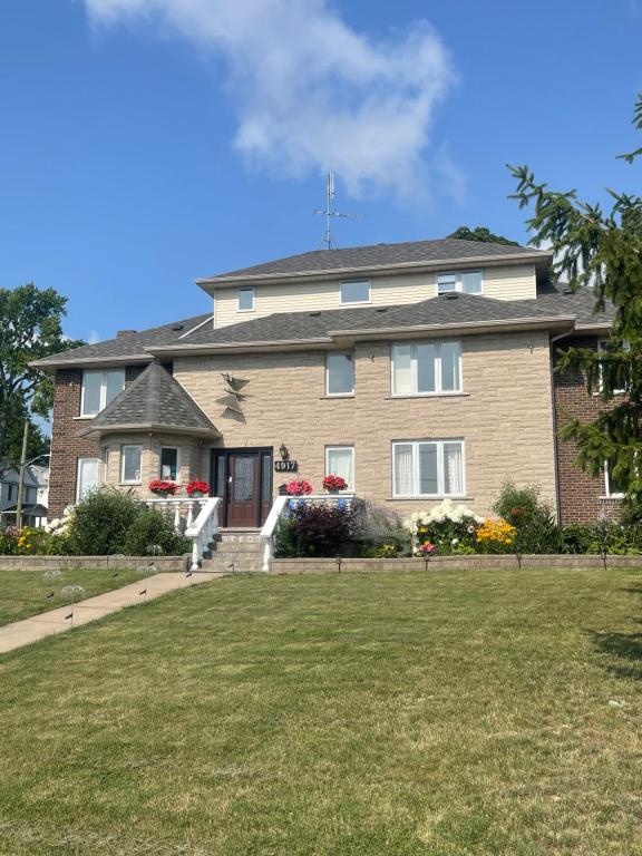 a large house with a lawn in front of it at Butterfly Manor in Niagara Falls
