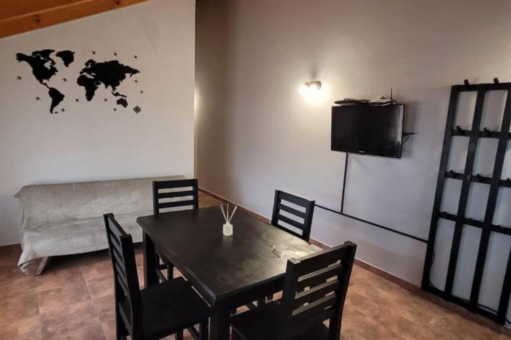 a dining room with a table and a television at Blue House 5 Villa La Angostura in Villa La Angostura