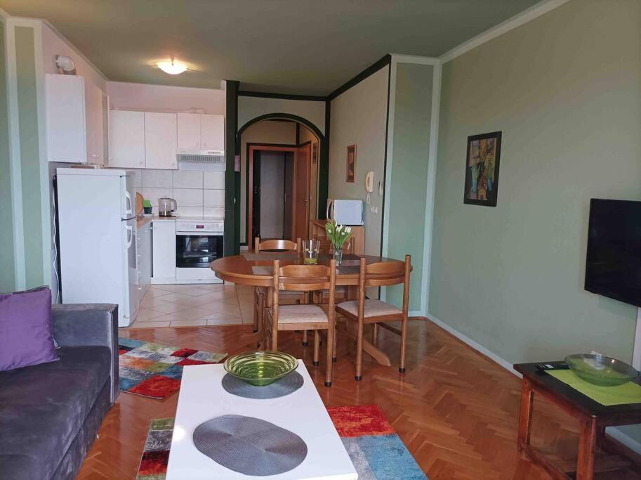 a living room with a couch and a table at Meeresblick Apartment S4 in Promajna