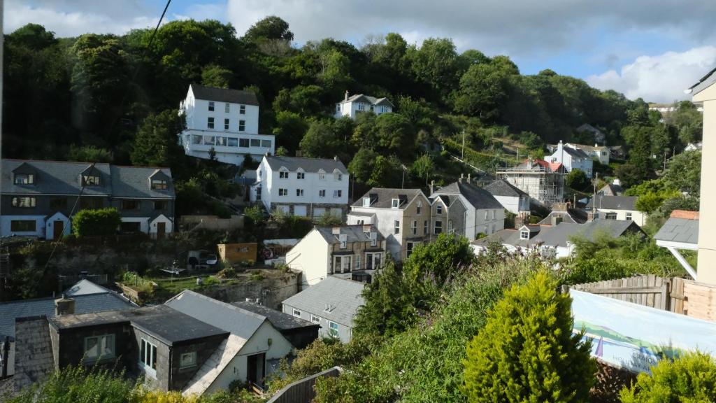 a town on a hill with houses at Commanders Cabin EV point in Looe
