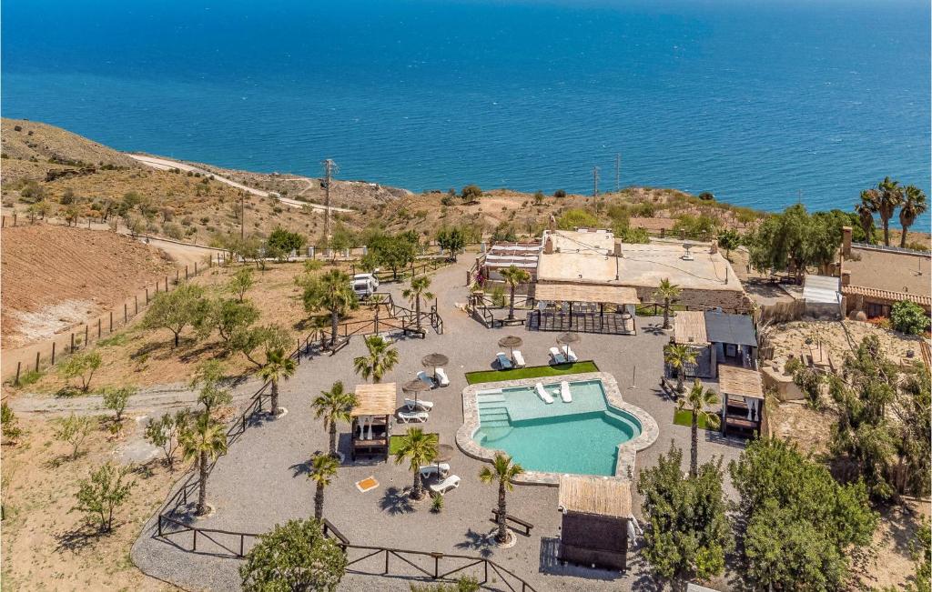 an aerial view of a resort with a swimming pool and the ocean at Cozy Home In Adra With House A Mountain View in Adra