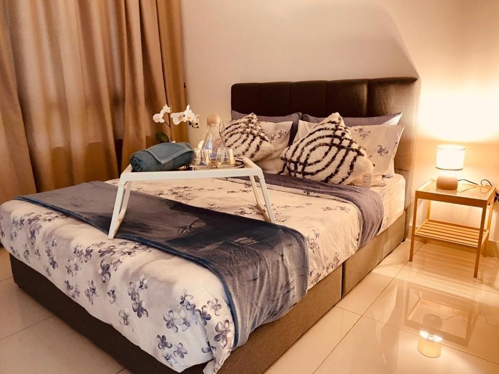 a bedroom with a bed with a tray on it at NEW Sunway Greenfield Home 2-6pax 5mins to Sunway Pyramid in Petaling Jaya