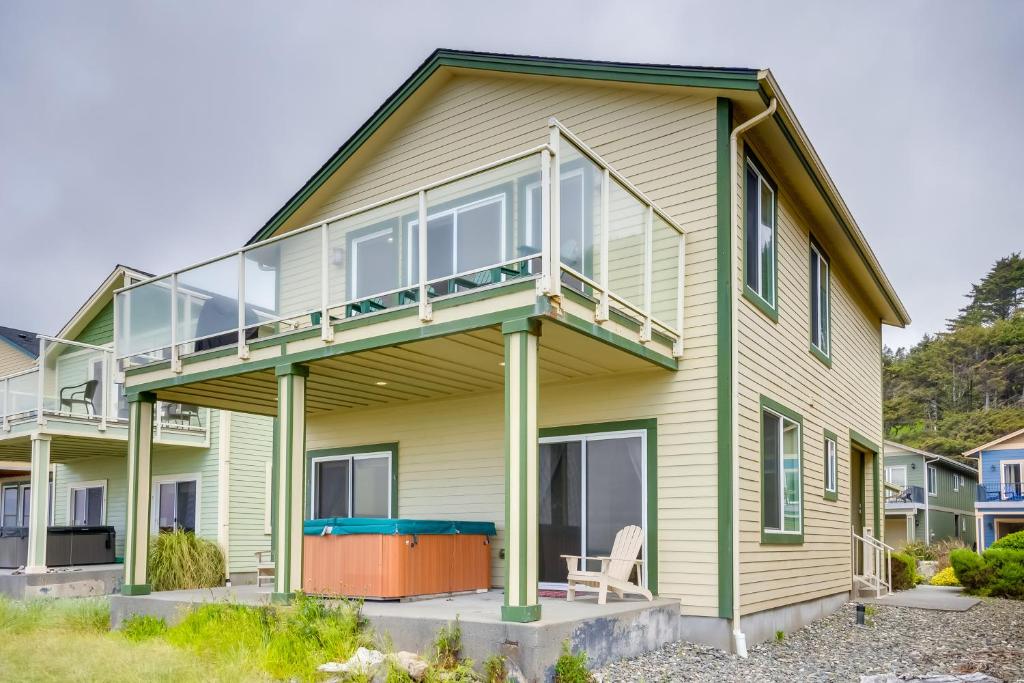 a house with a wrap around porch with a deck at Gold Beach Retreat Private Hot Tub and Ocean Views! in Gold Beach