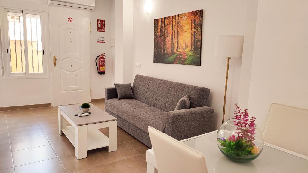 a living room with a couch and a table at Cuchillos de la fonseca in Casas de Moya