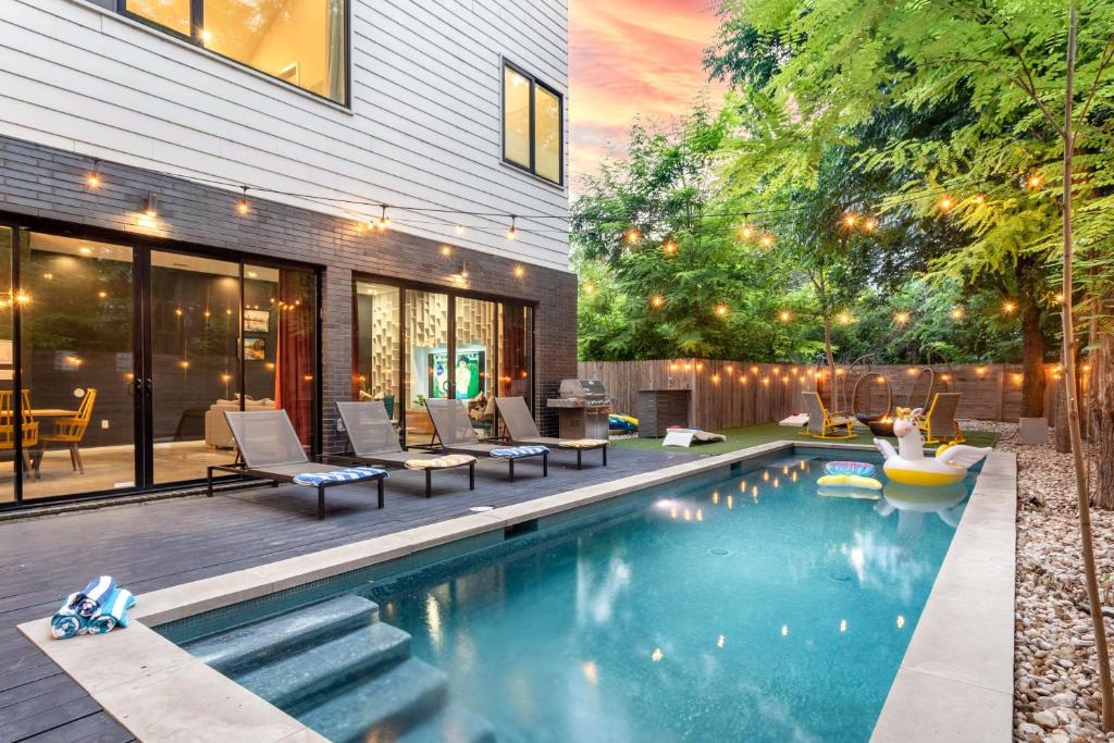a backyard with a swimming pool and a house at Backyard Pool Oasis - Rainey Street - 6 min walk in Austin