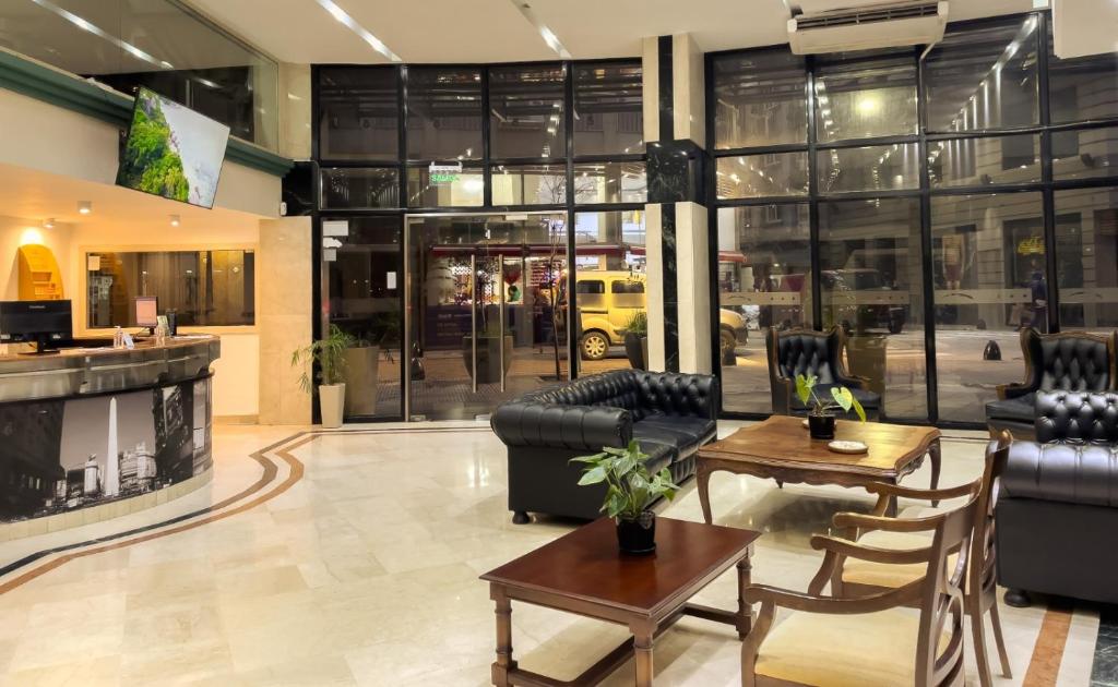 a lobby with couches and tables in a building at Hotel HR Plaza Luxor in Buenos Aires
