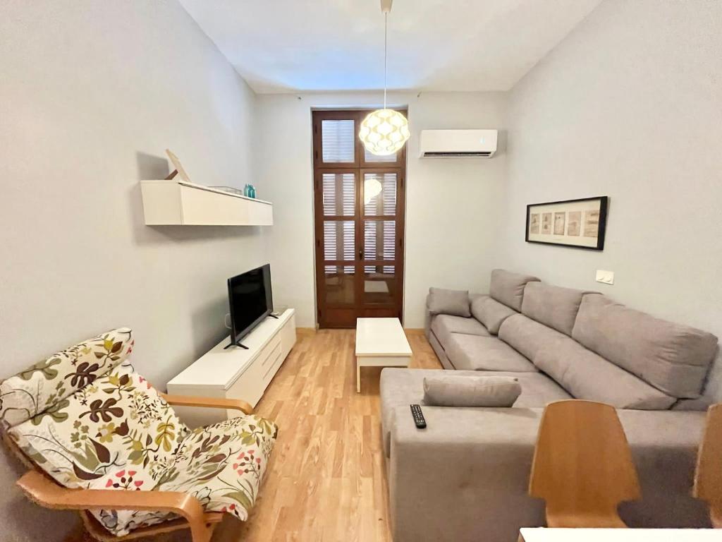 a living room with a couch and a tv at Triana 3 in Melilla