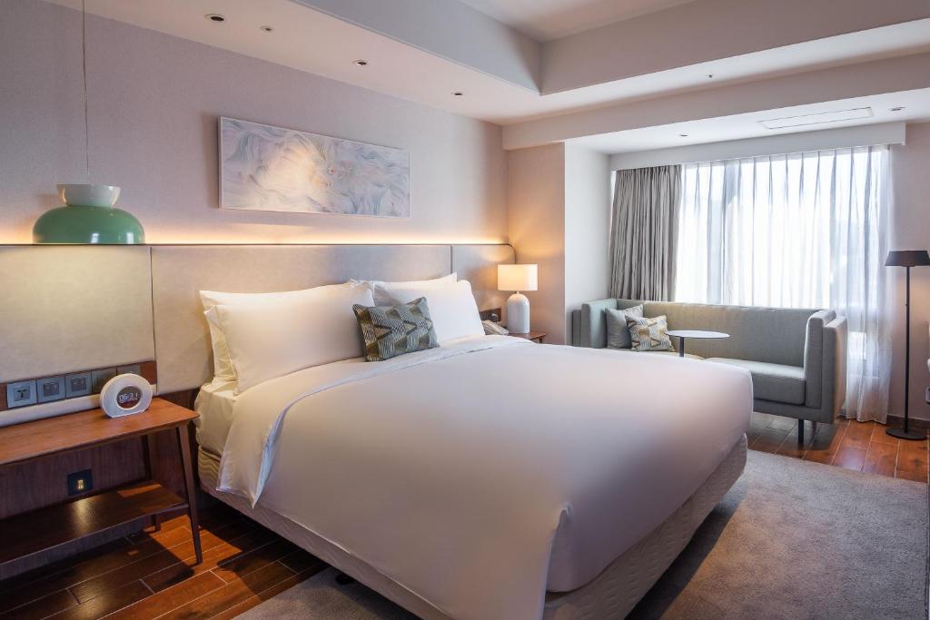 Postel nebo postele na pokoji v ubytování Kilin Hotel, JiaoXi