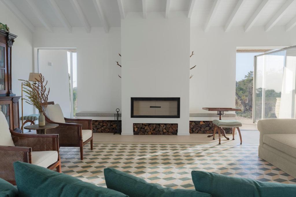 a living room with a couch and a fireplace at Amaria in Aljezur
