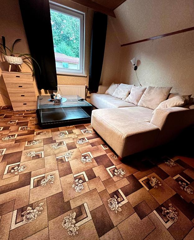 ein Schlafzimmer mit einem Bett und einem Tisch auf einer Etage in der Unterkunft Retro bungalow in Liepāja