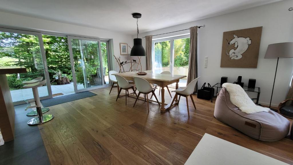 a living room with a dining room table and chairs at Tegernsee Chalet in Gmund am Tegernsee