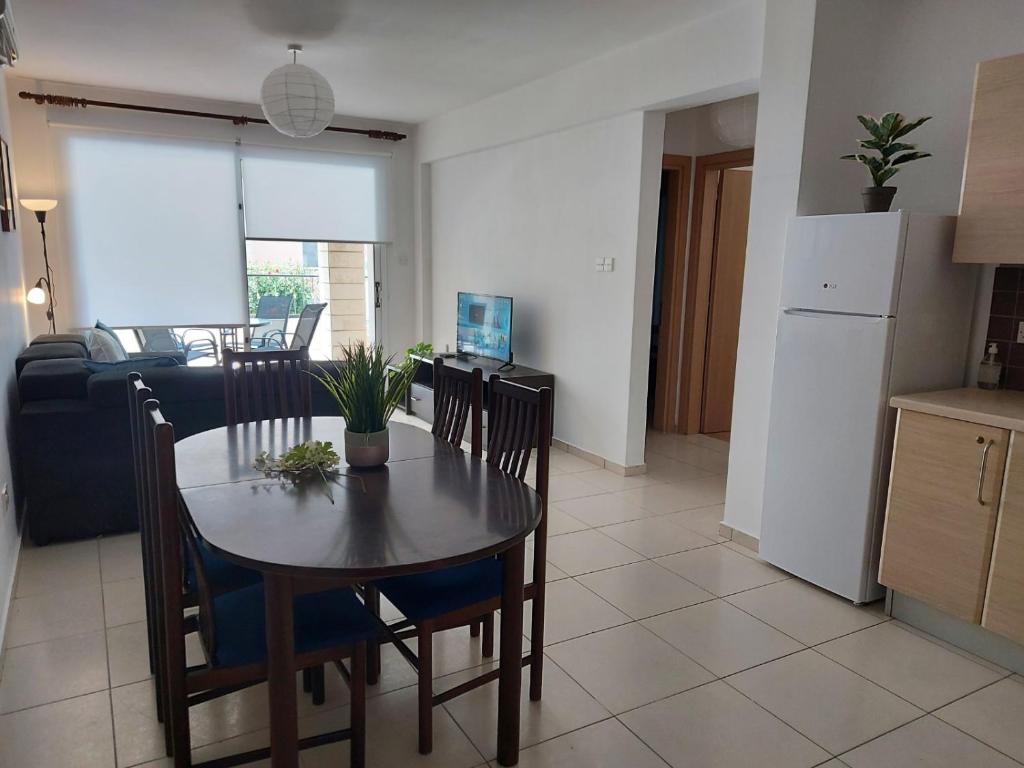 a kitchen and dining room with a table and chairs at Pyla Palms Resort B1 - 1 in Larnaca