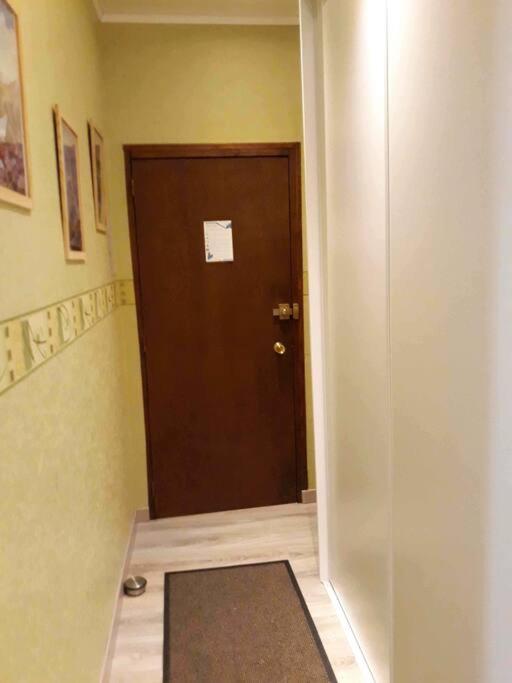 a hallway with a door with a mat in front of it at Bel appt 3 * plein Centre ville 4 pers. + balcon in Cauterets