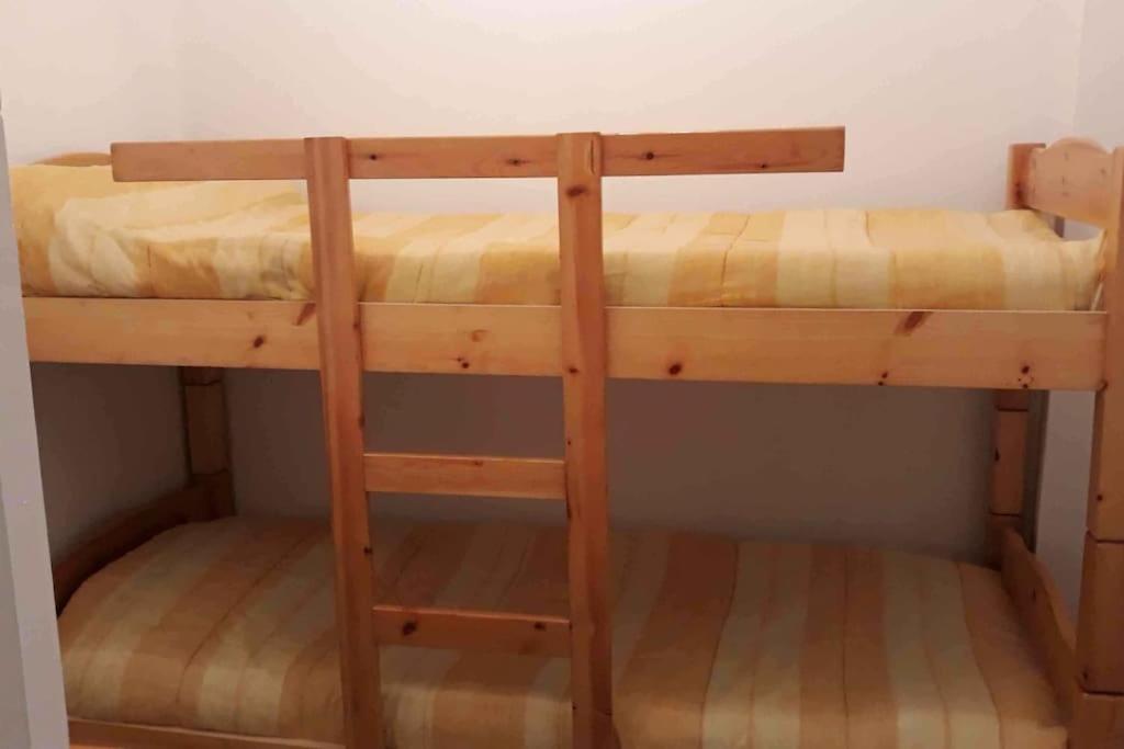 a bunk bed in a room with two bunk beds at Bel appt 3 * plein Centre ville 4 pers. + balcon in Cauterets