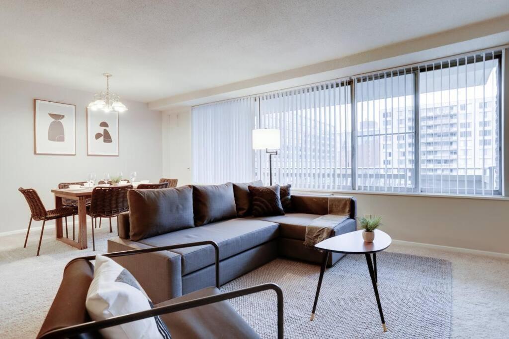 a living room with a couch and a table at Elegant Condo with Gorgeous Views at Crystal City in Arlington