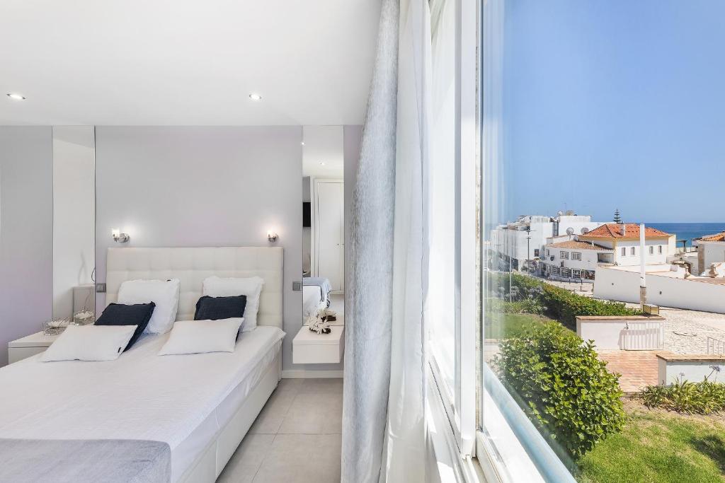 En eller flere senge i et værelse på Coração do Mar by OCvillas