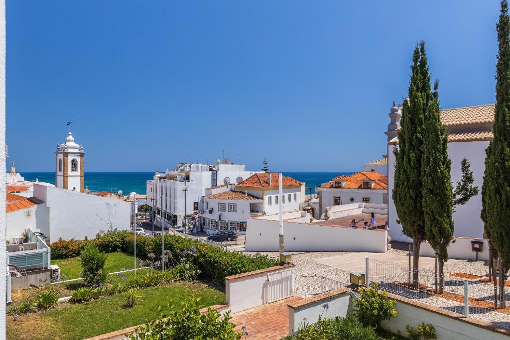 a view of a city with the ocean in the background at Coração do Mar by OCvillas in Albufeira