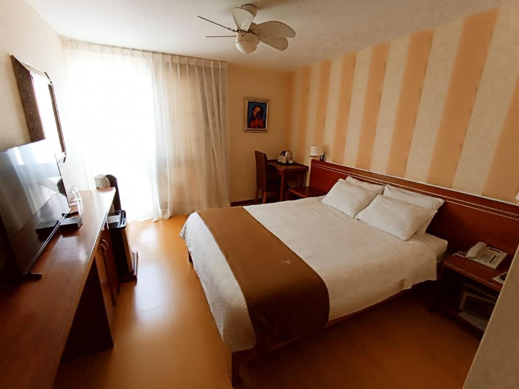 Ένα ή περισσότερα κρεβάτια σε δωμάτιο στο Hotel Boutique Runcu Miraflores