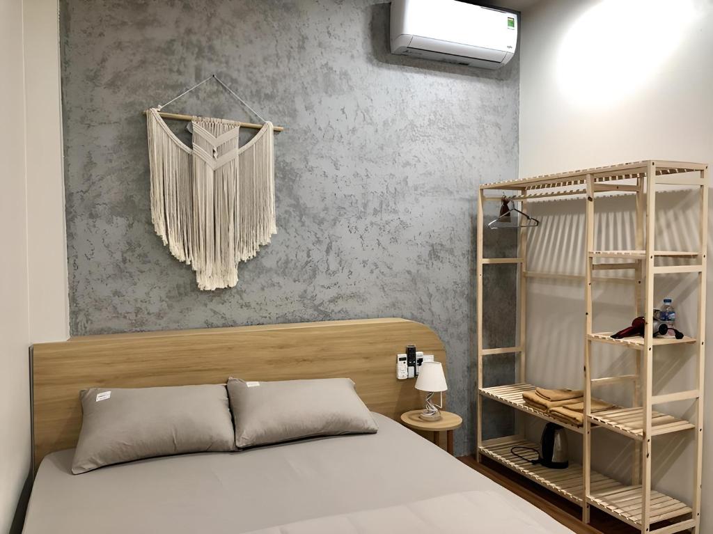 a bedroom with a bed and a shelf at Tít Mít HomeStay in Cao Bằng