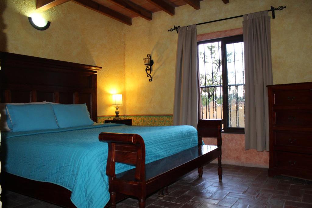 a bedroom with a large bed and a window at Hotel Casa Caro in Bernal