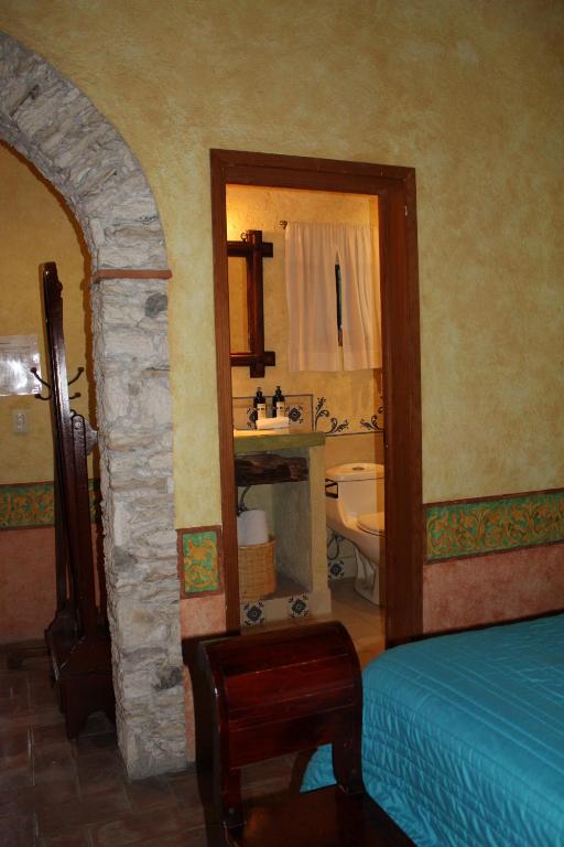 Postel nebo postele na pokoji v ubytování Hotel Casa Caro
