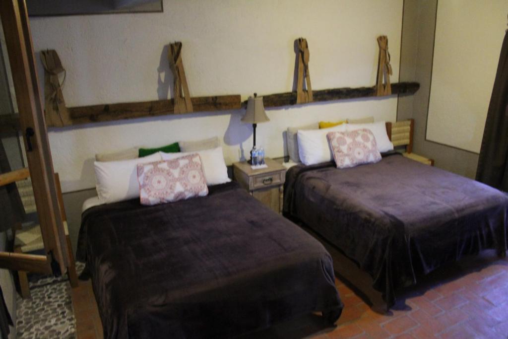 Postel nebo postele na pokoji v ubytování Hotel Casa Caro