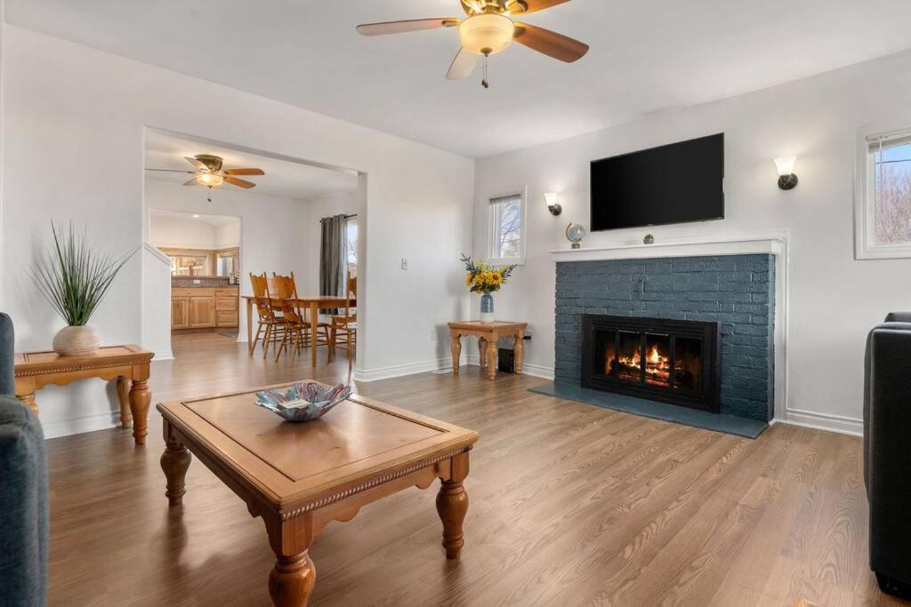 a living room with a fireplace and a tv at Large Fenced Yard and Outdoor Patio in Lewiston