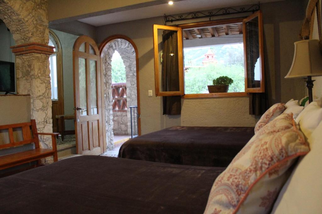 Postel nebo postele na pokoji v ubytování Hotel Casa Caro