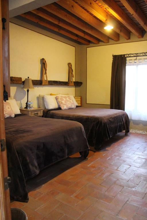 Postel nebo postele na pokoji v ubytování Hotel Casa Caro