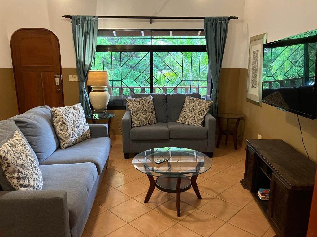 a living room with a couch and a table at Villa Tortuga in Nosara