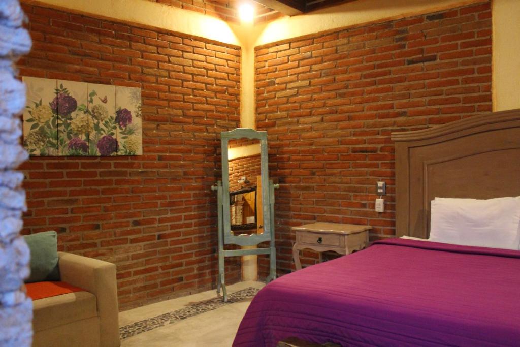 Postel nebo postele na pokoji v ubytování Hotel Casa Caro