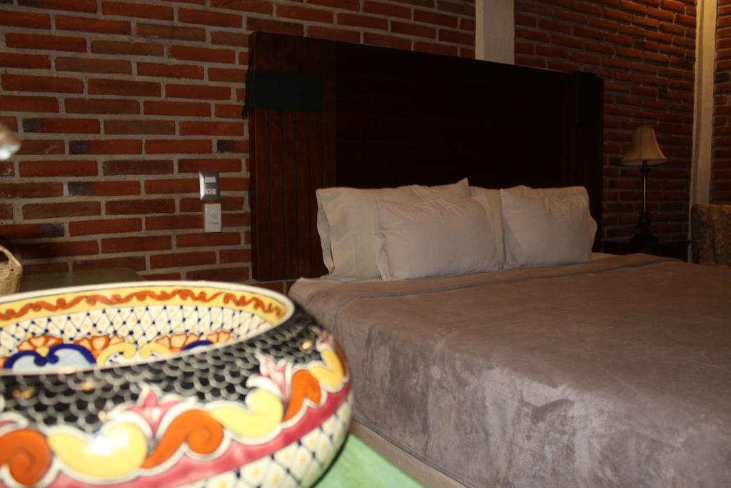 Postel nebo postele na pokoji v ubytování Hotel Casa Caro
