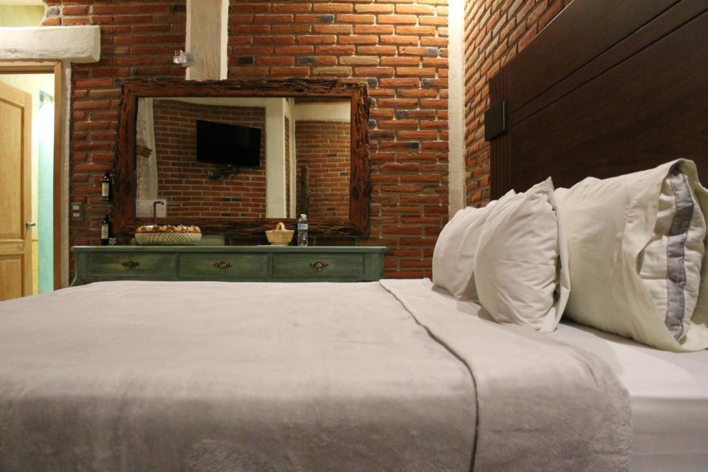 Postel nebo postele na pokoji v ubytování Hotel Casa Caro