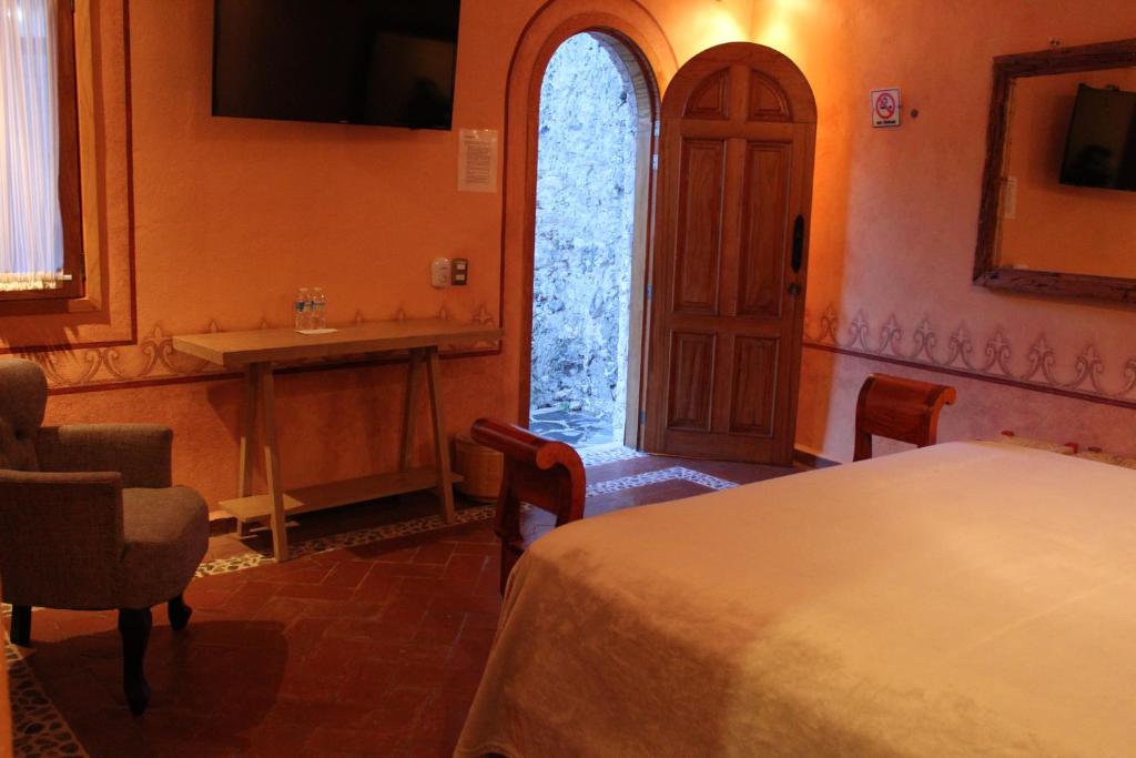 Postel nebo postele na pokoji v ubytování Hotel Casa Caro