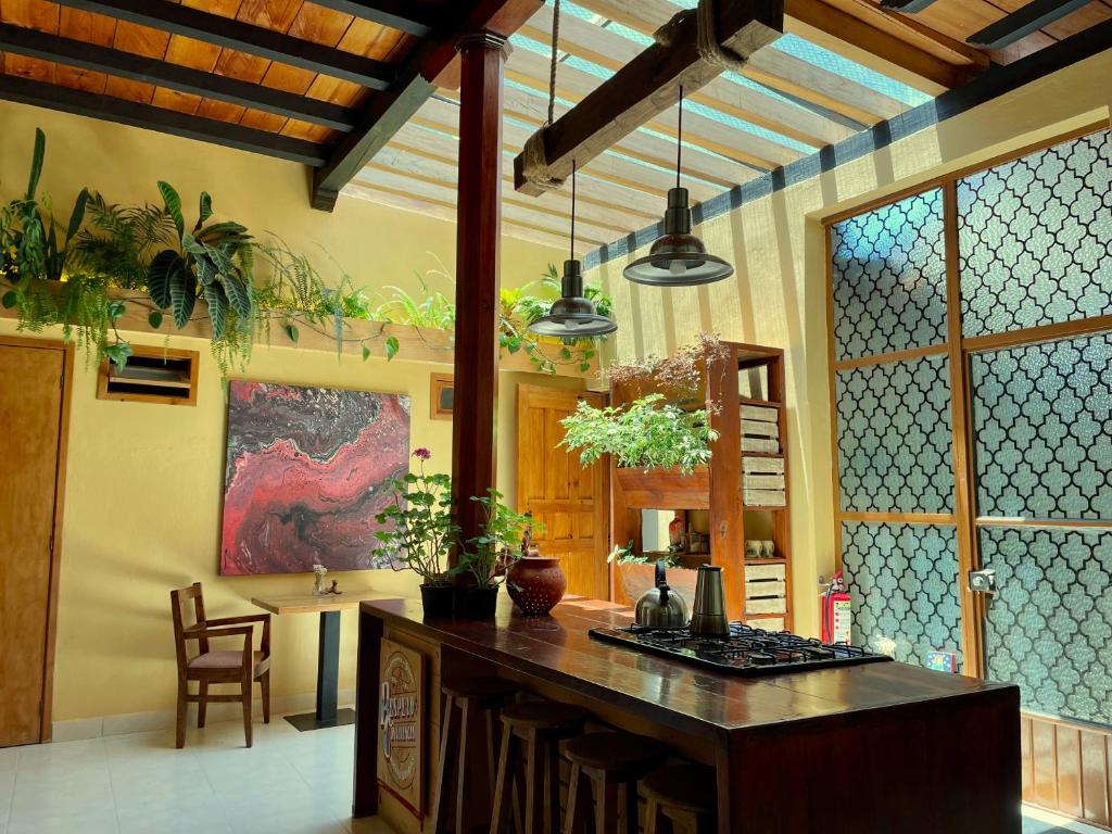 a kitchen with a island in the middle of a room at Hotel Casa Azabache in San Cristóbal de Las Casas