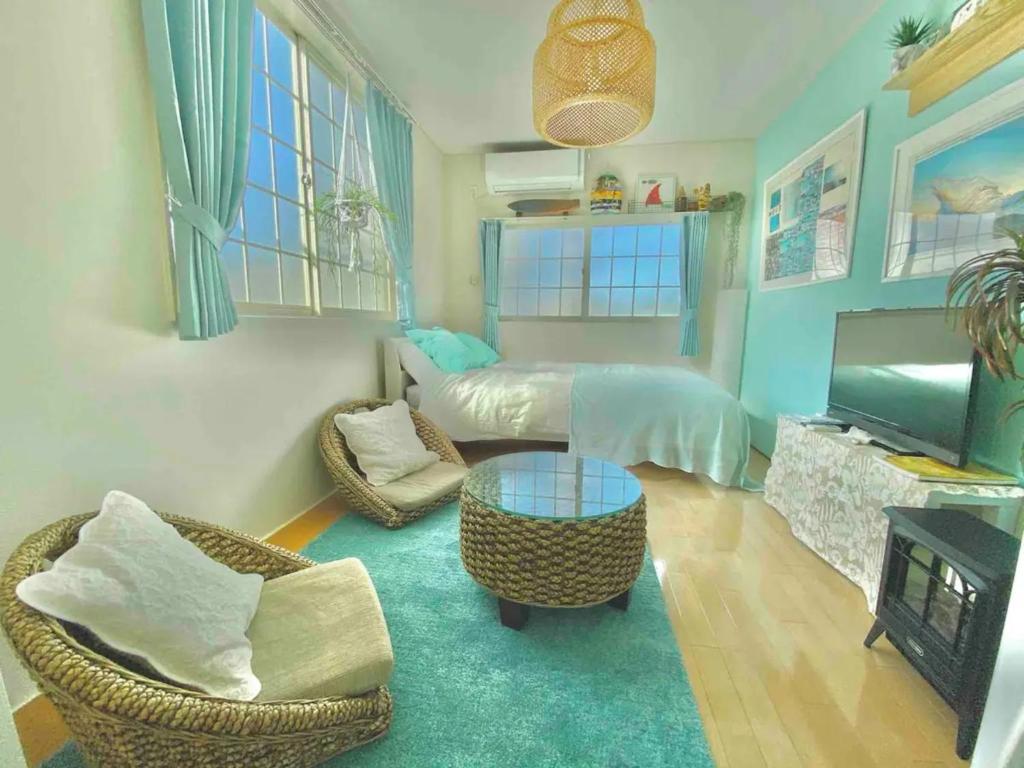 a living room with a bed and a table and a couch at Enoshima Beach - Vacation STAY 07405v in Fujisawa