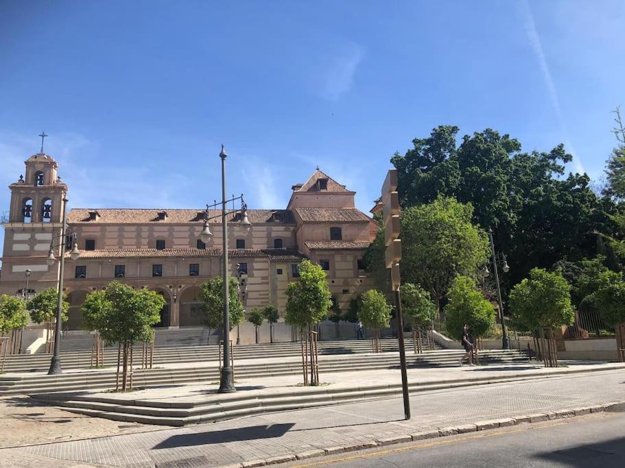 ein großes Gebäude mit Bäumen davor in der Unterkunft 4 Bedroom House in City Centre with Your Own Private Roof Terrace in Málaga