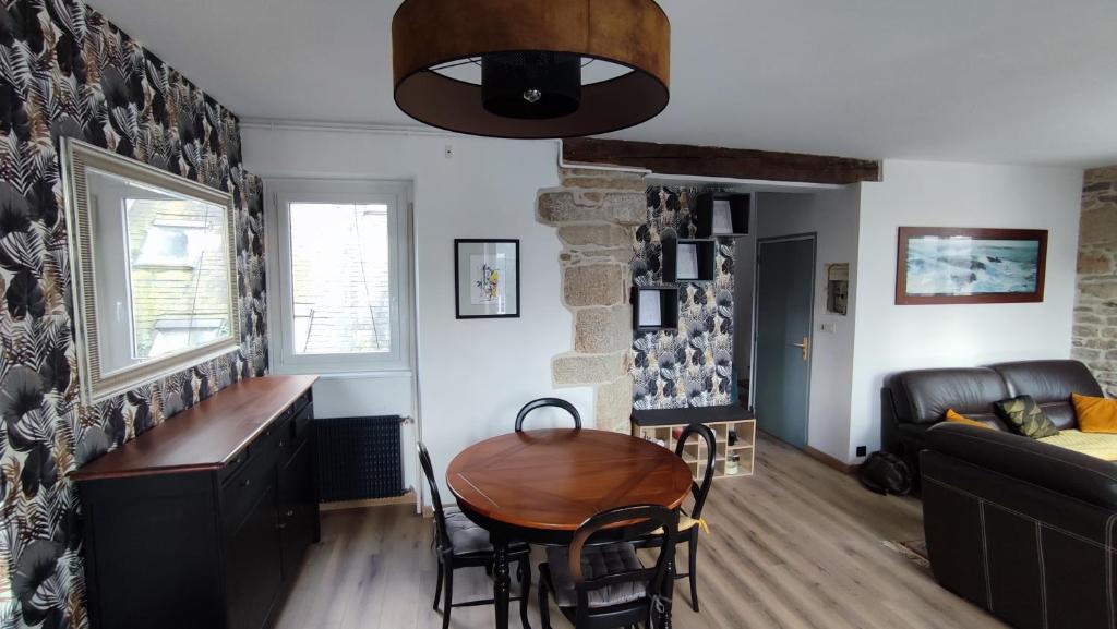 a living room with a table and a couch at le panoramique in Quimper