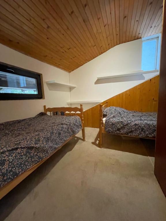 a room with two beds and a window at Skikoliba 1 in Jahorina