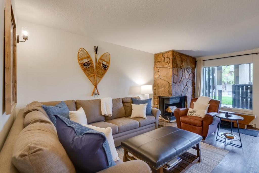 a living room with a couch and a table at Walk to Ski Shuttle: Cozy Mountain Meadows Condo in Frisco
