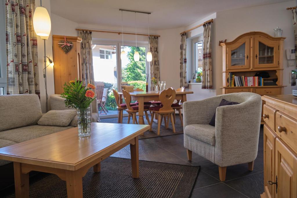 a kitchen and living room with a table and chairs at Haus Nicola in Bad Gastein