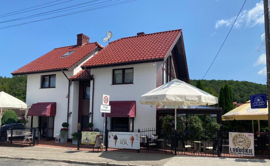 a white building with a red roof at Cafe Duo in Wisełka