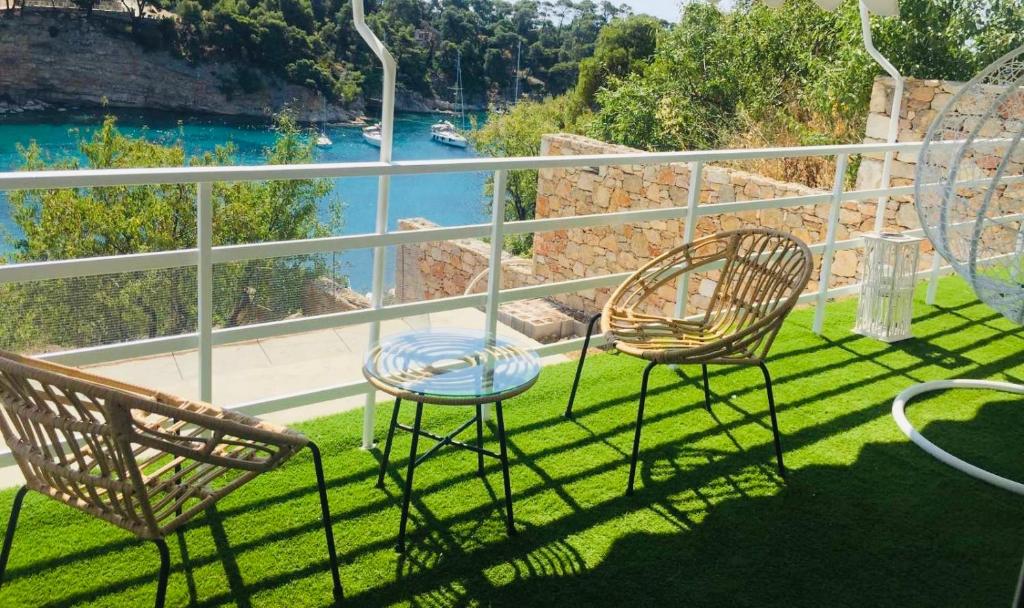 two chairs and a table on a balcony overlooking the water at D & A LAND in Alonnisos