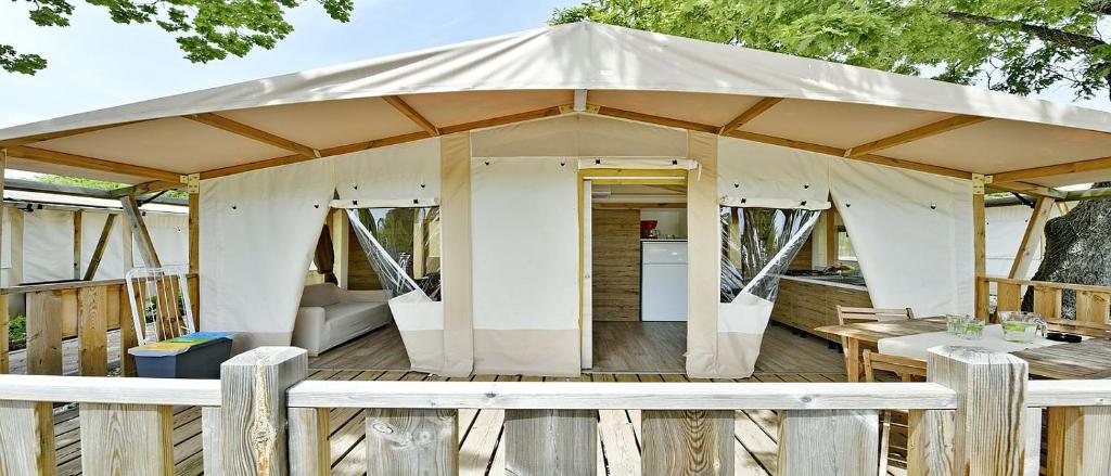 a gazebo with a table and a couch at Polidor Glamping Resort in Poreč