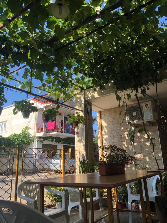 a table and chairs on a patio with a building at Casa Petre in Eforie Nord